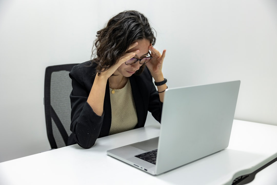 Stressed woman at her laptop at Gestoría G1 upon receiving a tax notice from the Spanish Tax Agency in Mallorca